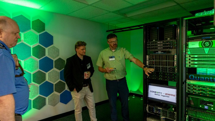 Men pointing at a computer.